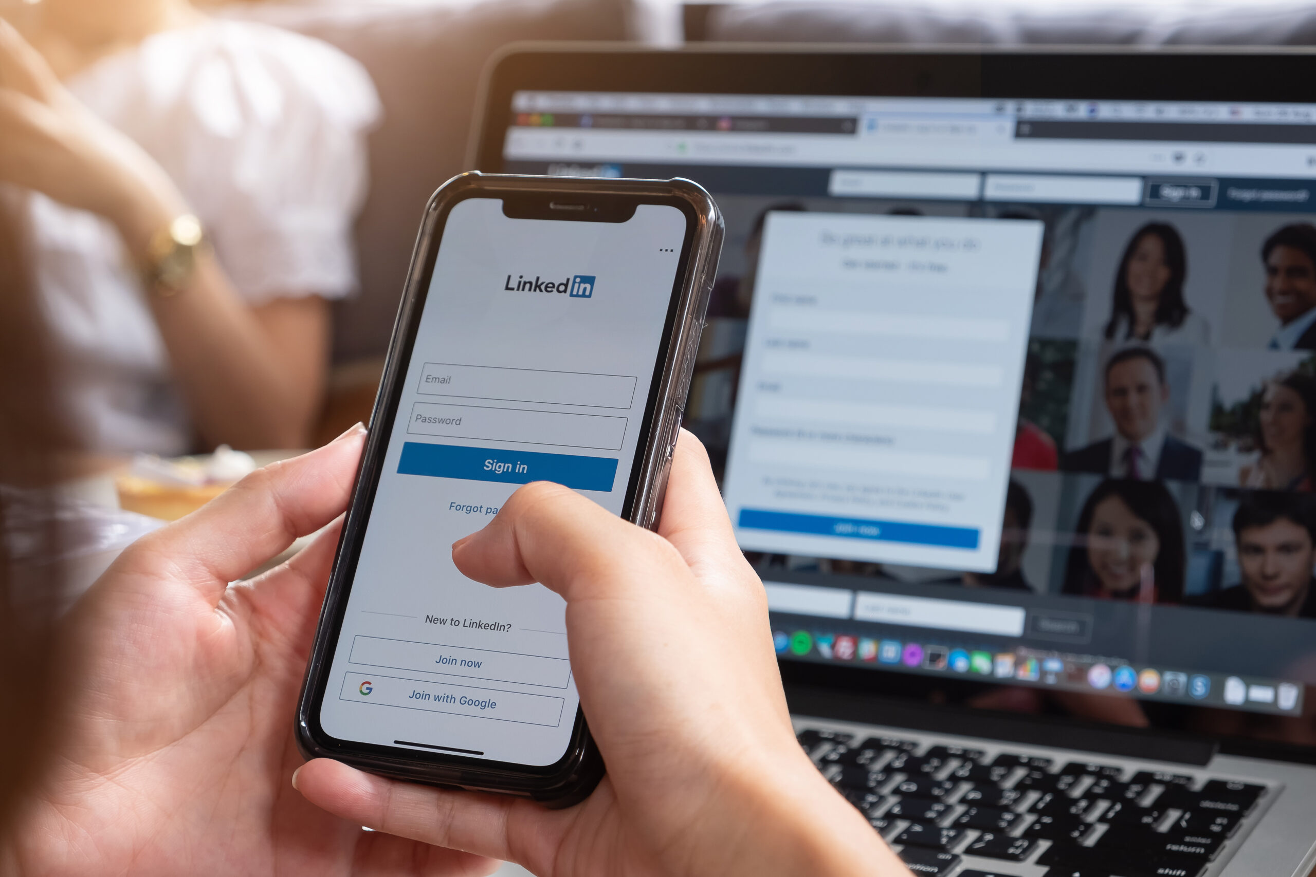 LinkedIn login form on a phone with Email and Password fields and a Sign in button.