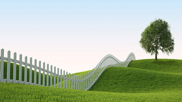 White wavy fence crosses rolling green hills under a blue sky with a lone tree on the right.